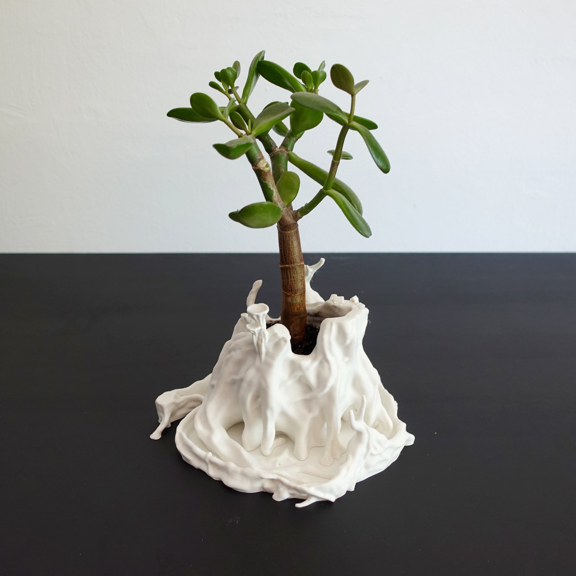 A small planter in the shape of a tree trunk